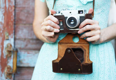 Girl with retro camera. Vintage.の写真素材