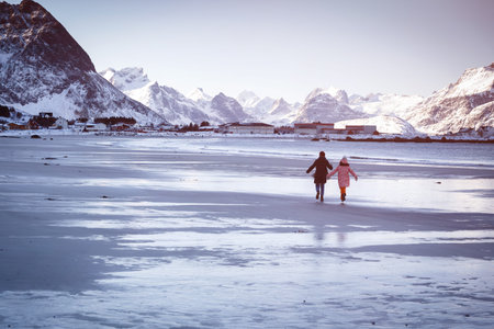 beautiful Norwegian landscape at the Lofoten Islands. Norway. girls walk on an empty winter beach