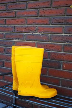 yellow rubber boots near the entrance to the houseの写真素材