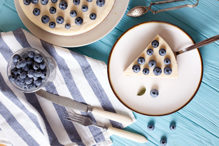 cheesecake with blueberry on a blue wooden backgroundの写真素材