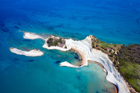 aerial view of sheer white cliffs of Cape Drastis near Peroulades village on Corfu Island in Greeceの写真素材