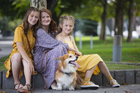 mom with daughters and dog corgi. dog in the familyの写真素材
