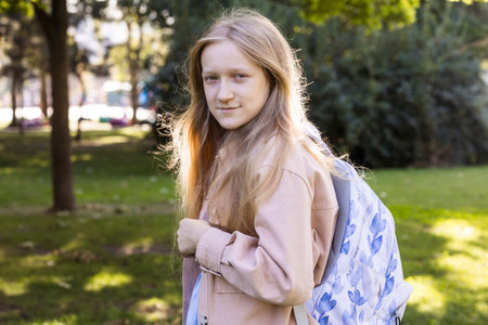 beautiful schoolgirl with a backpack outdoor