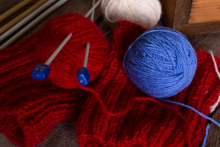 hobby. knitting - set of multicolored balls threads and knitting needles on a wooden tableの写真素材