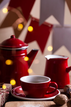 christmas background. red teapot, cup and cezve on the background of flagsの写真素材