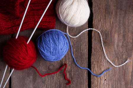 hobby. knitting - set of multicolored balls threads and knitting needles on a wooden tableの写真素材