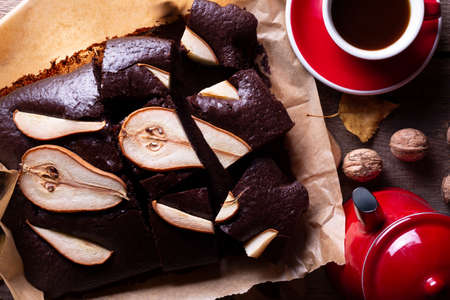 chocolate pie with pears. coffee pot and cup. still life and autumn backgroundの写真素材
