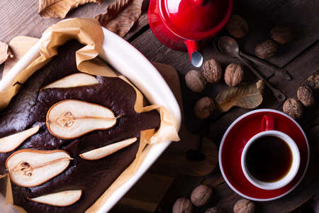 chocolate pie with pears. coffee pot and cup. still life and autumn backgroundの写真素材