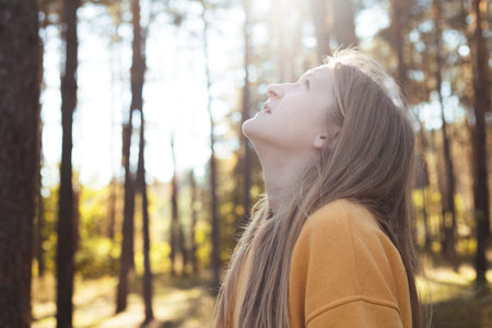 portrait beautiful happy girl in the forest at sunset time