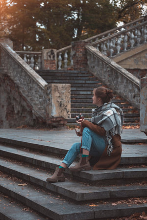 autumn in the city. Girl with retro camera taking pictures