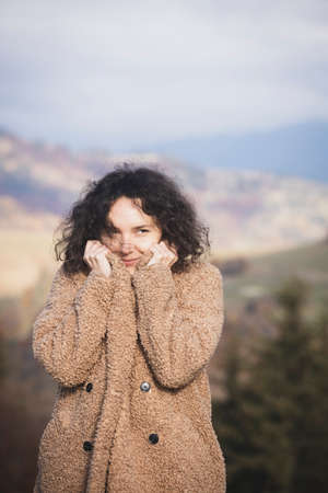portrait of a happy smiling girl against the background of the mountainsの写真素材