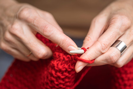 hobbies and leisure. girl knits a red scarf