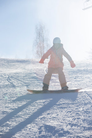happy girl in ski resort riding snowboard. winter sportsの写真素材