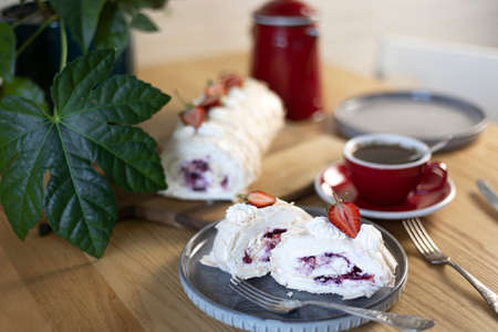 meringue roll with strawberries. beautiful summer dessert for breakfastの写真素材