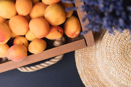 summer background of apricot, lavender and straw hatの写真素材