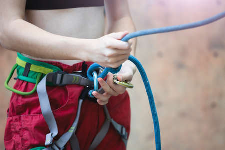 bouldering, girl climbing up the wallの写真素材