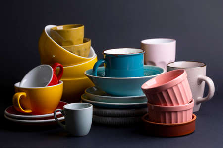 bright ceramics - bowl and cups in colorful colors on a black backgroundの写真素材