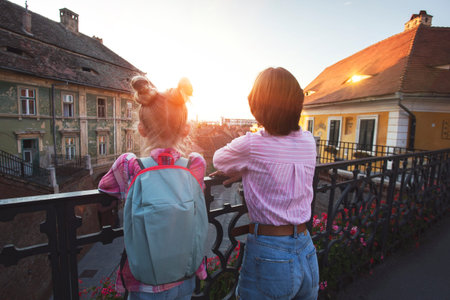 two girls sisters walking around the old town of Sibiu, Romaniaの写真素材