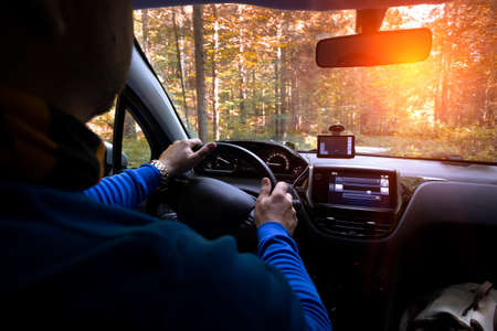 roadtrip - mans hands on the wheel and mountains in the backgroundの写真素材