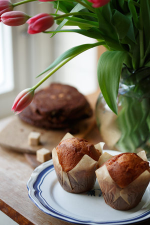 beautiful pink tulips in a vase with cupcakes and cookies in the vintage kitchen