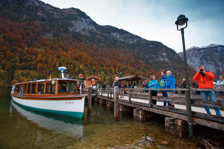 KONIGSSEE, GERMANY - OCTOBER 20, 2019: people on the pier waiting for a boat ride on the lake. Konigssee, Germanyのeditorial素材