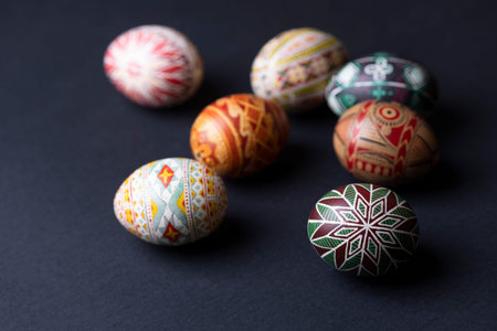 happy easter card. beautiful Easter egg Pysanka handmade on a black background
