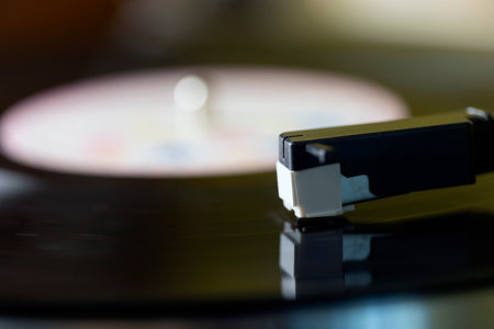 close up view of the turn table with the spinning vinil disc and the needleの写真素材