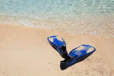 flippers for diving on the sand near the seaの写真素材
