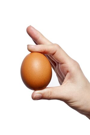 an egg in his hand, isolated on white backgroundの写真素材