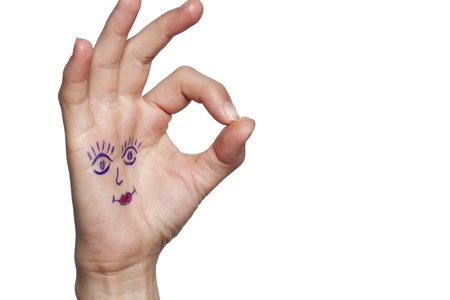 Female hand with painted eyes and lipsの写真素材