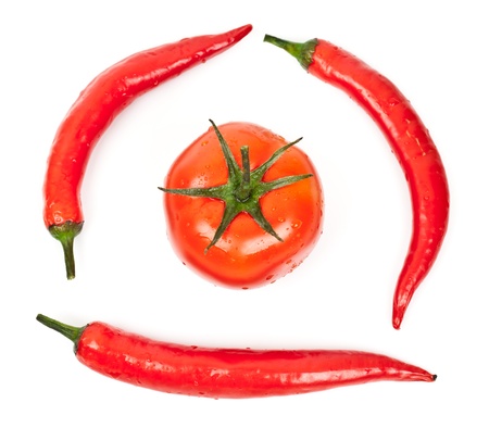 tomatoes and hot peppers on a white backgroundの写真素材