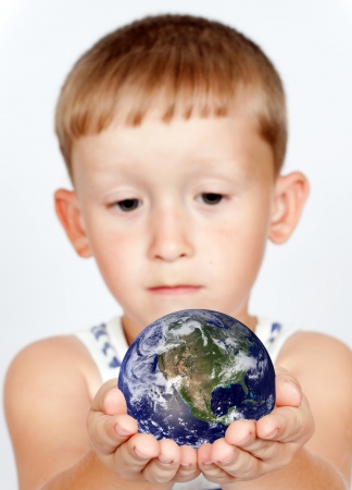 a boy holding a globeの写真素材