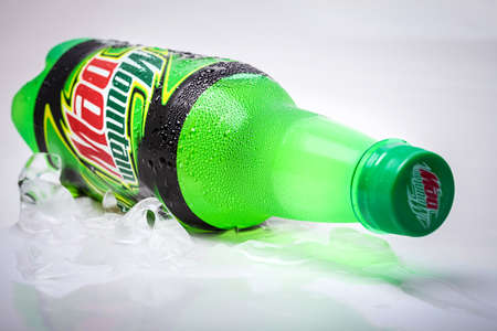 SABAH, MALAYSIA - january 13, 2015: Bottle of Mountain Dew drink on ice isolated on white. Mountain Dew citrus-flavored soft drink produced by PepsiCo. Mountain Dew was introduced in 1940のeditorial素材