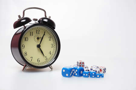 Play time. Dice and analogue clock showing 5 o'clock isolated on white background.の写真素材
