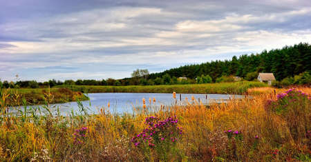 House on the lake in the early autumnの写真素材