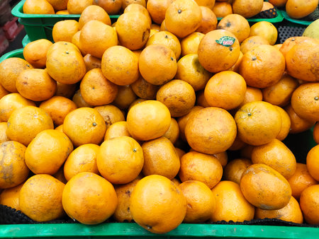 Orange fruit in the market. Close up of a pile of oranges.の写真素材