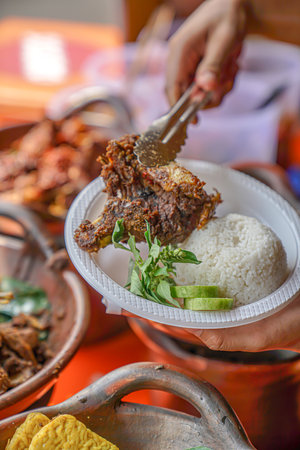 Put the duck meat into a plastic plateの写真素材