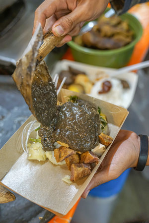 Minced meat ketupat coated in peanut sauce