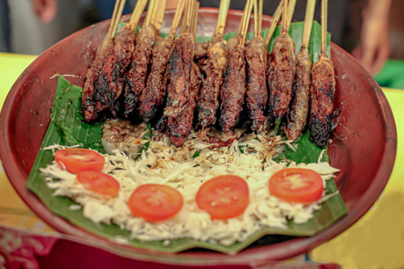 On the earthen jug plate there is Balinese typical bongkot satayの写真素材