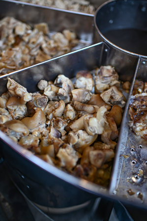 Pieces of pork knuckle in a meatball boilerの写真素材