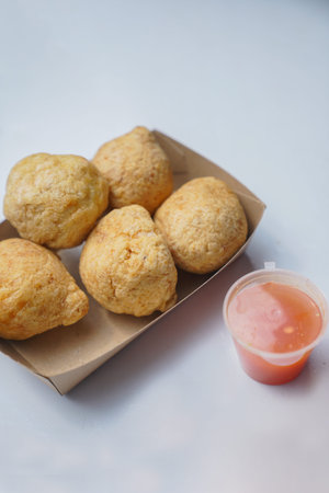 Appearance of fried meatballs and sauce on a white background