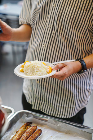 Jackfruit milk sticky rice held by a customer who has already purchased it