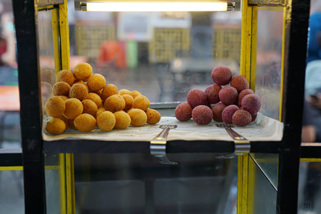 Hollow sweet potato balls in the display case are for saleの写真素材