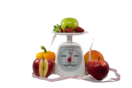 Healthy Fruits to loss weight with Scale and measuring tape on white backgroundの写真素材