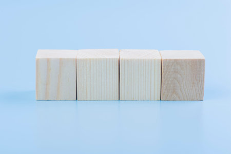 Blank natural wooden cube block horizontal on blue backgroundの写真素材