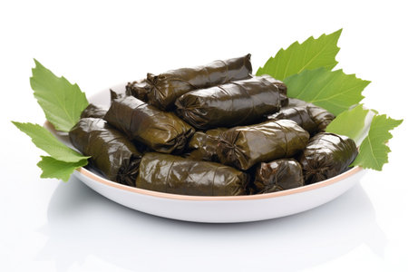 Stuffed grape leaves on a plate isolated on a white background.の素材
