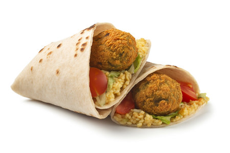 Tortilla with falafel and vegetables isolated on white backgroundの素材