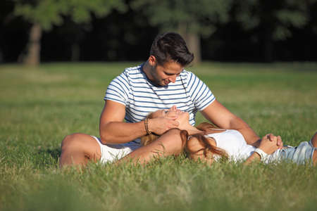 Romantic moments between a couple in the parkの写真素材