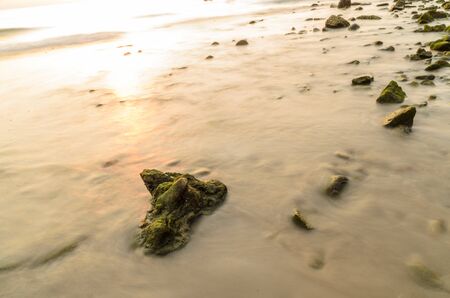 Rocks on the beach in the evening.の写真素材