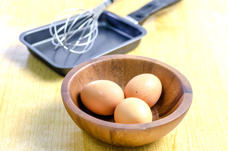 Egg and pan on a wooden tableの写真素材